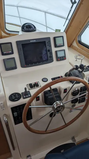 Sea Ranger Yacht Photos Pics 2008 Sabre 34 Express boat helm with navigation instruments and wooden steering wheel.