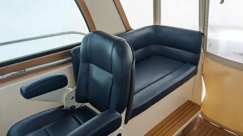 Sea Ranger Yacht Photos Pics 2008 Sabre 34 Express interior with blue leather seating and wooden accents.