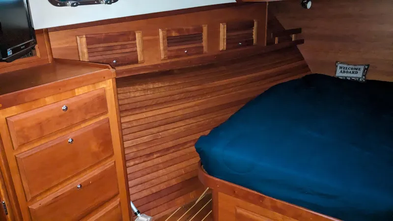 Sea Ranger Yacht Photos Pics Interior cabin of 2008 Sabre 34 Express with wooden cabinetry and blue bedding.