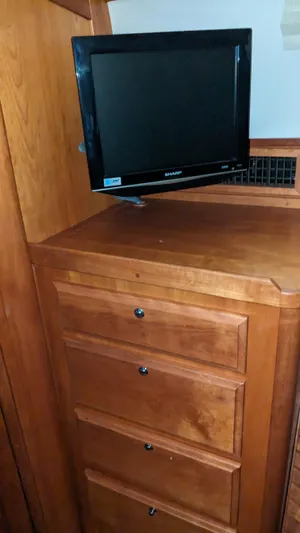 Sea Ranger Yacht Photos Pics Wooden dresser with a mounted TV in a 2008 Sabre 34 Express boat.