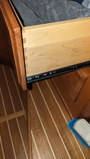 Sea Ranger Yacht Photos Pics Open drawer in 2008 Sabre 34 Express boat interior with wooden flooring.