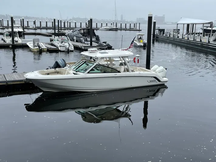  Yacht Photos Pics 2020 Boston Whaler 320 Vantage docked in calm marina waters.