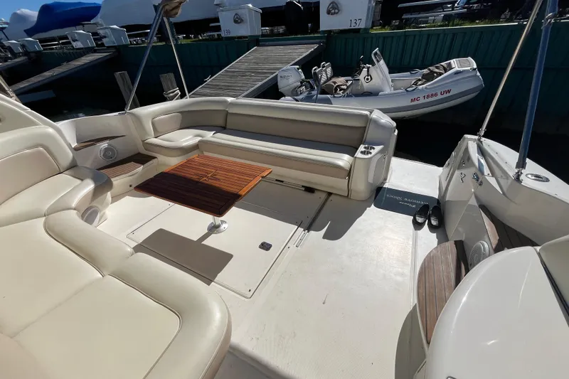 A Friend Like Me Yacht Photos Pics 2000 Sea Ray 460 Sundancer yacht interior with beige seating and wooden table.