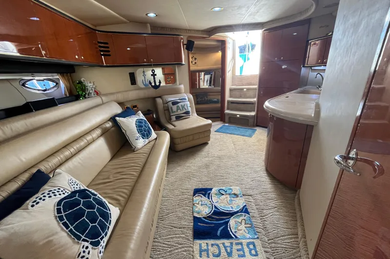 A Friend Like Me Yacht Photos Pics Luxurious interior of 2000 Sea Ray 460 Sundancer yacht with plush seating and nautical decor.