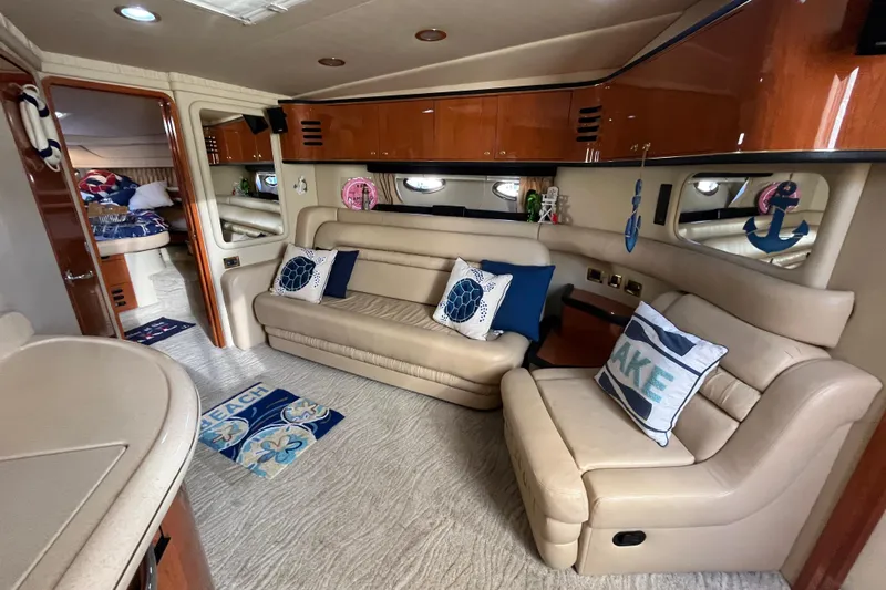 A Friend Like Me Yacht Photos Pics Luxurious interior of 2000 Sea Ray 460 Sundancer yacht with plush seating and nautical decor.
