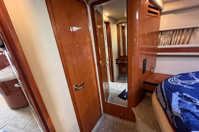 A Friend Like Me Yacht Photos Pics Interior of 2000 Sea Ray 460 Sundancer yacht with wood finishes and cozy bedroom.