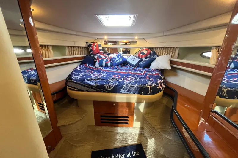 A Friend Like Me Yacht Photos Pics Luxurious cabin interior of 2000 Sea Ray 460 Sundancer yacht with nautical bedding.