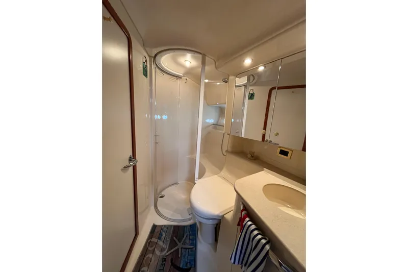 A Friend Like Me Yacht Photos Pics Bathroom interior of 2000 Sea Ray 460 Sundancer yacht, featuring shower and sink.