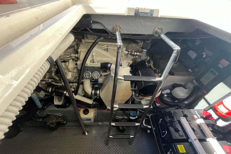A Friend Like Me Yacht Photos Pics Engine room of a 2000 Sea Ray 460 Sundancer with visible components and ladder.
