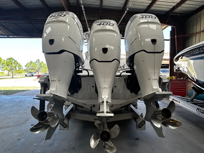  Yacht Photos Pics 2016 Nor-Tech 390 Sport boat with triple 400 horsepower engines in a garage.