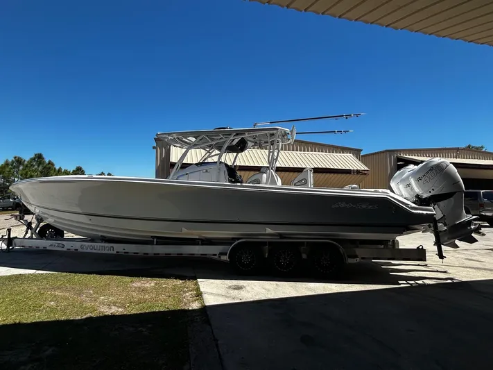  Yacht Photos Pics 2016 Nor-Tech 390 Sport boat on trailer, parked outdoors under clear blue sky.