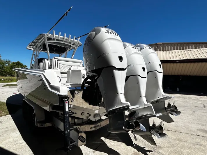  Yacht Photos Pics 2016 Nor-Tech 390 Sport boat with triple outboard engines, parked outdoors.