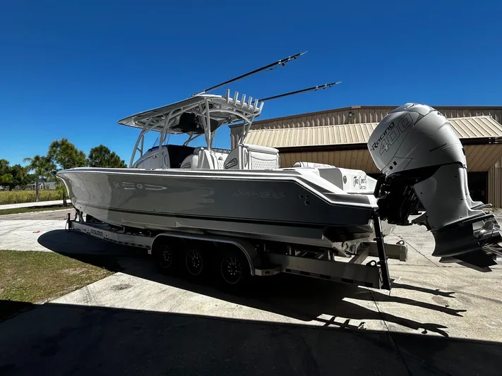  Yacht Photos Pics 2016 Nor-Tech 390 Sport boat on trailer, parked outdoors under clear blue sky.