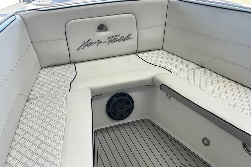  Yacht Photos Pics 2016 Nor-Tech 390 Sport boat interior with white cushioned seating and speaker.
