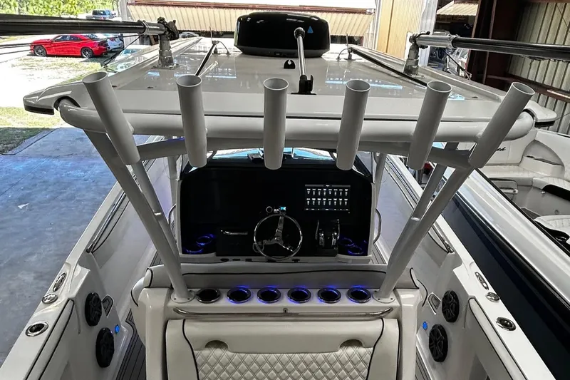  Yacht Photos Pics 2016 Nor-Tech 390 Sport boat interior with steering wheel and rod holders.