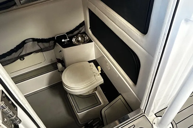  Yacht Photos Pics 2016 Nor-Tech 390 Sport boat interior with compact bathroom and toilet.