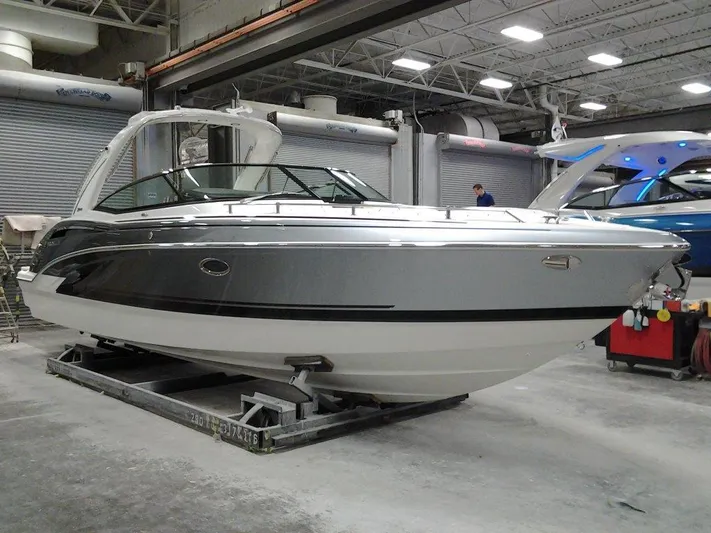 Banchors Ours Yacht Photos Pics 2018 Formula 310 Bowrider boat in a showroom, sleek design, silver and black exterior.