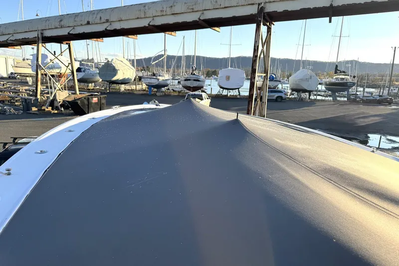 Fansea Pantz Yacht Photos Pics 2019 HCB 39 Speciale boat covered in a marina with other boats in the background.