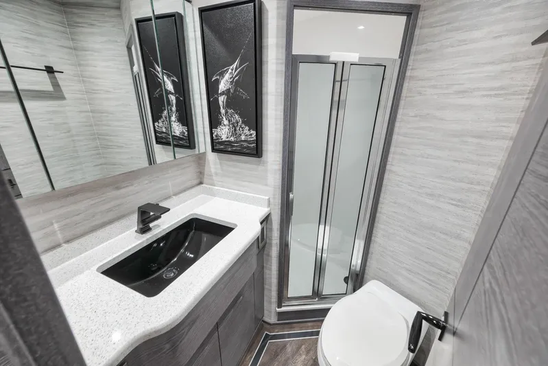 Lady Surfbum Yacht Photos Pics Luxurious bathroom in 2024 Viking 72 Convertible yacht, featuring modern fixtures and elegant design.