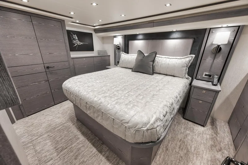 Lady Surfbum Yacht Photos Pics Luxurious bedroom interior of 2024 Viking 72 Convertible yacht with elegant furnishings.