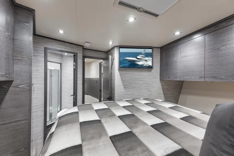 Lady Surfbum Yacht Photos Pics Luxurious 2024 Viking 72 Convertible yacht bedroom with modern decor and TV.