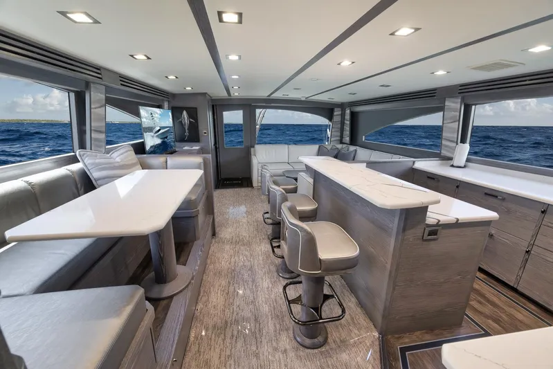 Lady Surfbum Yacht Photos Pics Luxurious interior of 2024 Viking 72 Convertible yacht with modern seating and ocean view.