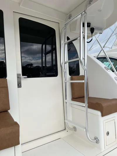  Yacht Photos Pics 2021 Henriques 50 Sportfisherman boat interior with ladder and seating.