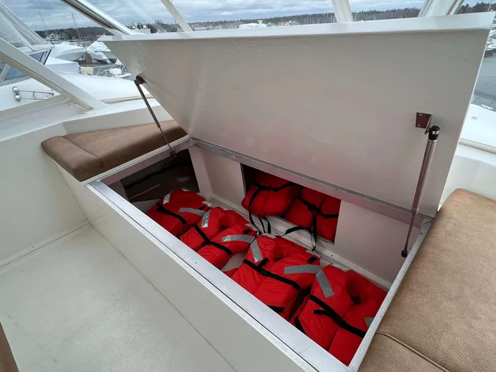  Yacht Photos Pics Storage compartment with life jackets on a 2021 Henriques 50 Sportfisherman boat.