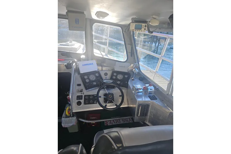 Gig Yacht Photos Pics Interior of a 1994 Custom SMW 38 boat cockpit with steering wheel and control panels.