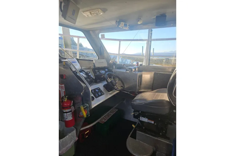 Gig Yacht Photos Pics Interior of a 1994 Custom SMW 38 boat cockpit with steering wheel and control panels.