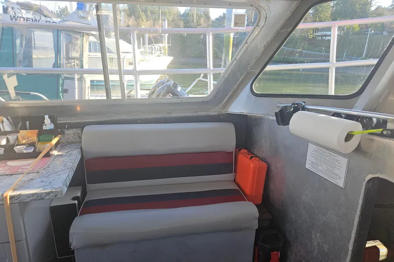 Gig Yacht Photos Pics Interior of a 1994 Custom SMW 38 boat with seating and dock view.