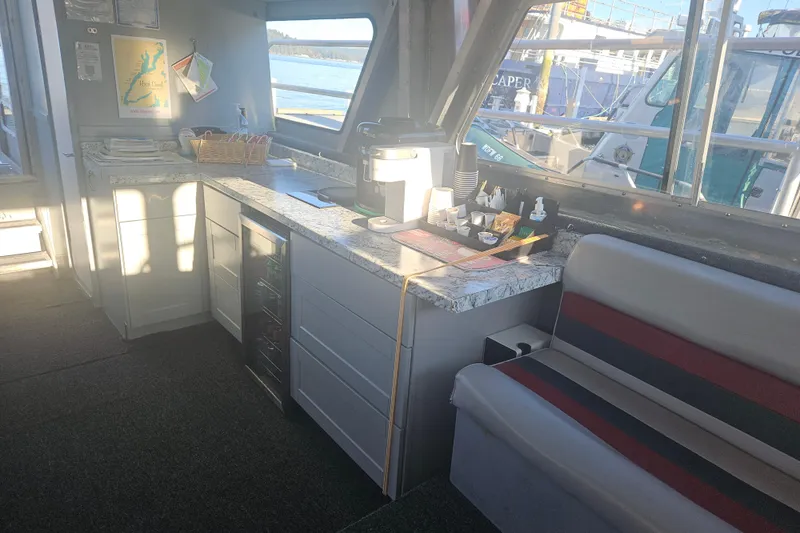 Gig Yacht Photos Pics Interior of a 1994 Custom SMW 38 boat with kitchenette and seating area.