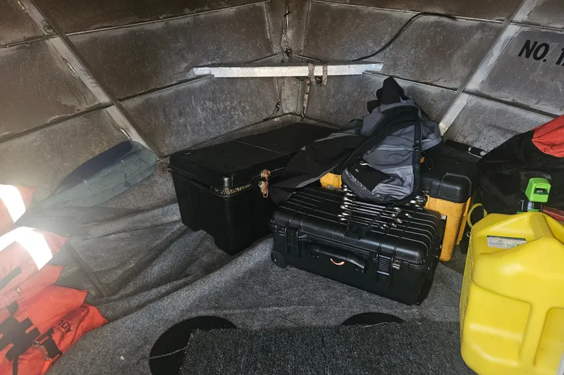 Gig Yacht Photos Pics Interior of a Custom SMW 38 (1994) boat with storage boxes and safety gear.