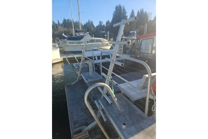 Gig Yacht Photos Pics Custom SMW 38 boat docked at marina, 1994 model, with metal framework and nearby vessels.