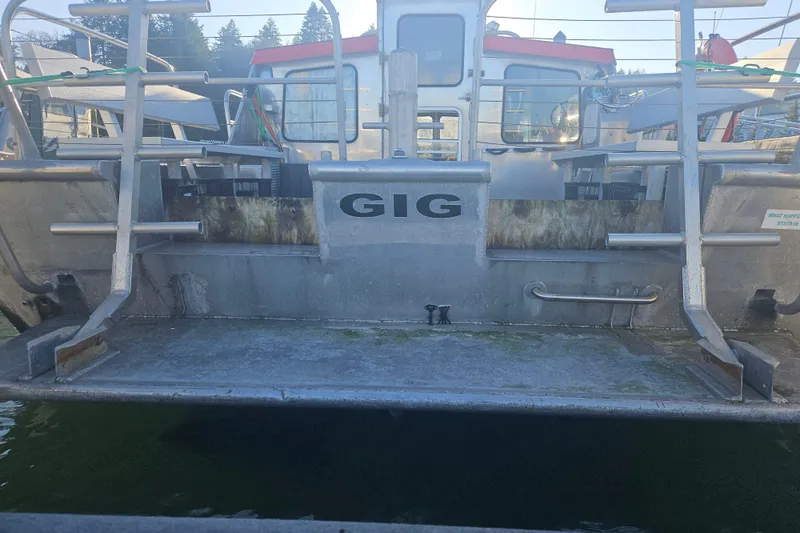 Gig Yacht Photos Pics Custom SMW 38 boat from 1994, docked with visible stern and railing.