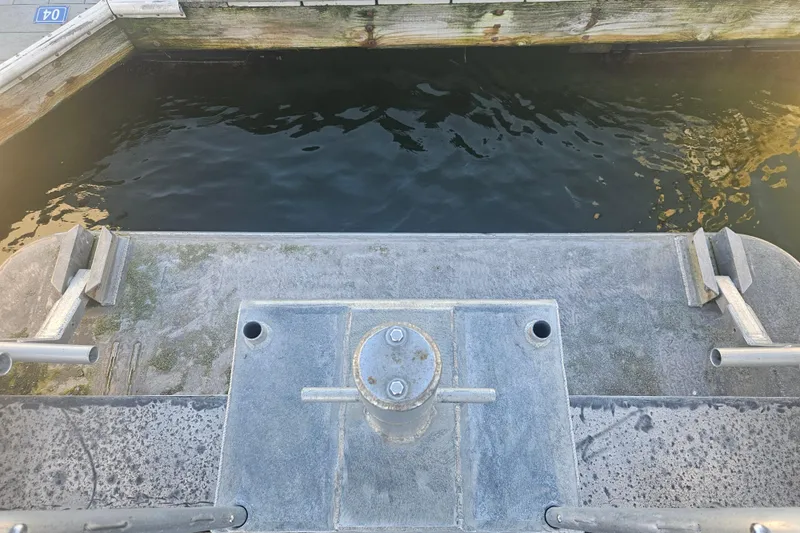 Gig Yacht Photos Pics Boat stern view at dock, Custom SMW 38, 1994 model, with water and wooden pier.