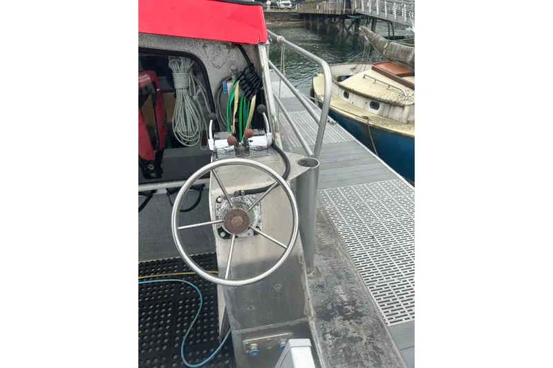 Gig Yacht Photos Pics Steering wheel of 1994 Svendsen Marine Works SMW 38 boat docked at marina.