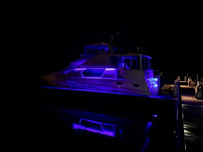  Yacht Photos Pics 2000 Silverton 453MY yacht illuminated with blue lights at night.