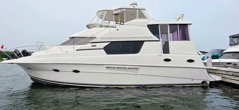  Yacht Photos Pics 2000 Silverton 453MY yacht docked at marina, side view.