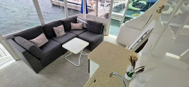  Yacht Photos Pics Luxurious interior of 2000 Silverton 453MY yacht with cozy seating and waterfront view.