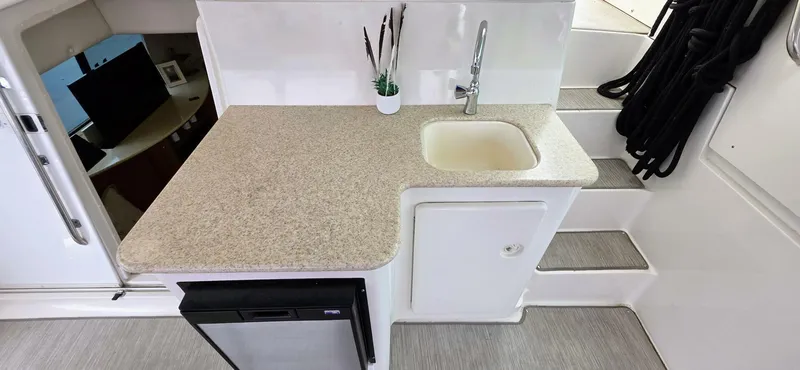  Yacht Photos Pics 2000 Silverton 453MY yacht kitchenette with sink, countertop, and mini fridge.
