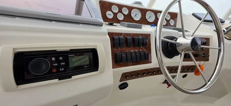  Yacht Photos Pics Control panel of a 2000 Silverton 453MY yacht with steering wheel and gauges.