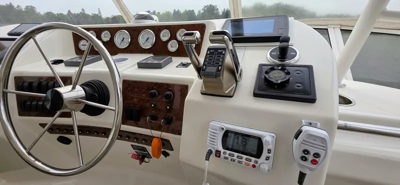  Yacht Photos Pics Helm of 2000 Silverton 453MY yacht with steering wheel, gauges, and navigation equipment.
