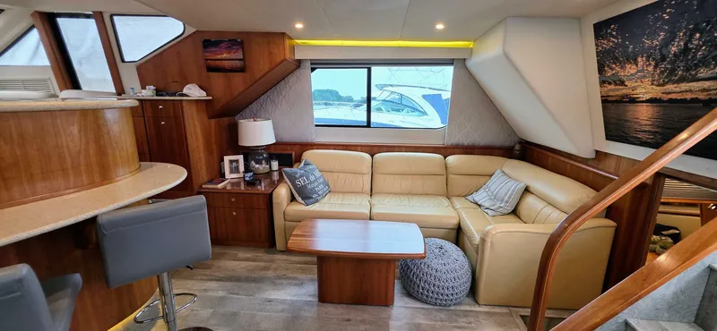 Yacht Photos Pics Luxurious interior of 2000 Silverton 453MY yacht with beige leather seating and wooden accents.
