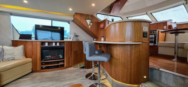  Yacht Photos Pics Luxurious interior of a 2000 Silverton 453MY yacht with modern furnishings and wood accents.