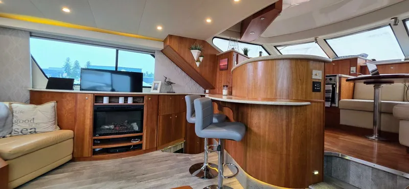  Yacht Photos Pics Luxurious interior of 2000 Silverton 453MY yacht with modern furnishings and entertainment area.