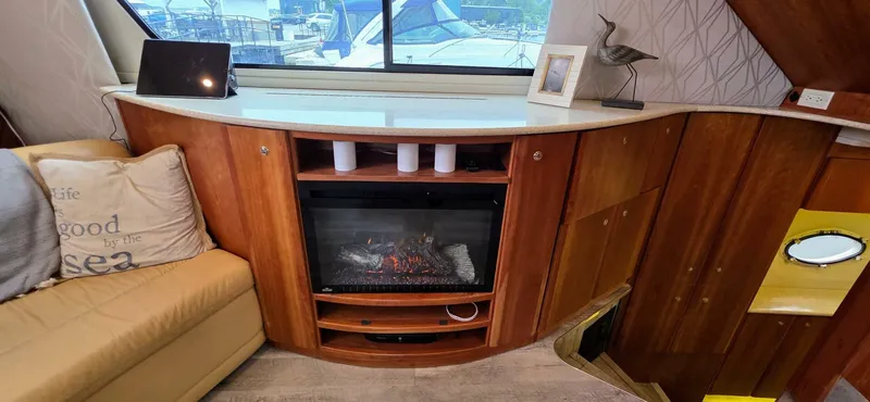  Yacht Photos Pics Interior of 2000 Silverton 453MY yacht with fireplace and wooden cabinetry.