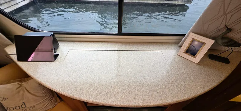  Yacht Photos Pics Interior view of a 2000 Silverton 453MY yacht with a window-side table.