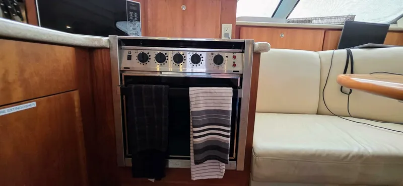  Yacht Photos Pics Interior of 2000 Silverton 453MY yacht with oven and seating area.