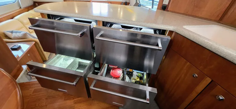  Yacht Photos Pics Modern kitchen drawers in a 2000 Silverton 453MY yacht, featuring sleek stainless steel design.